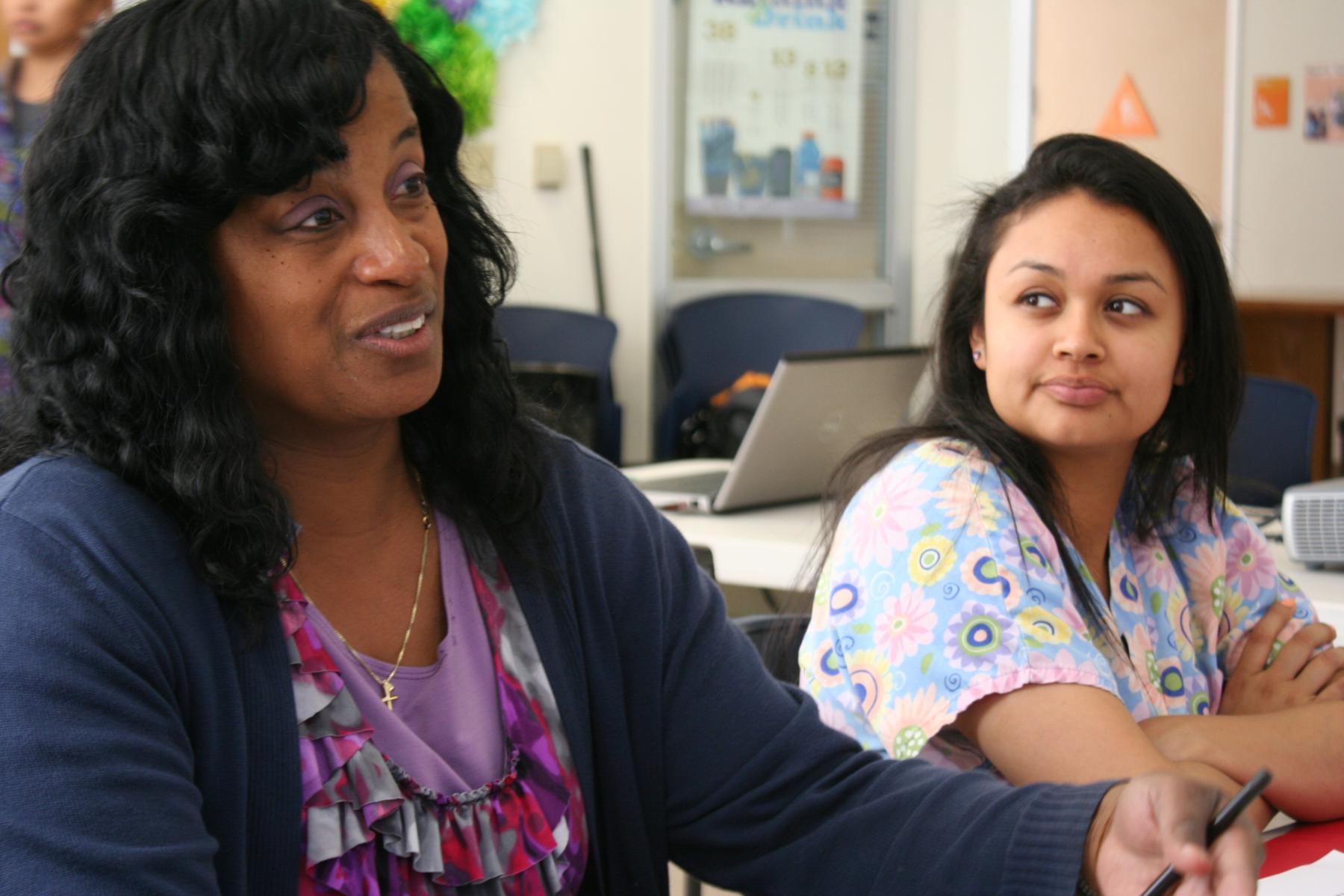Two adult learners in a training room