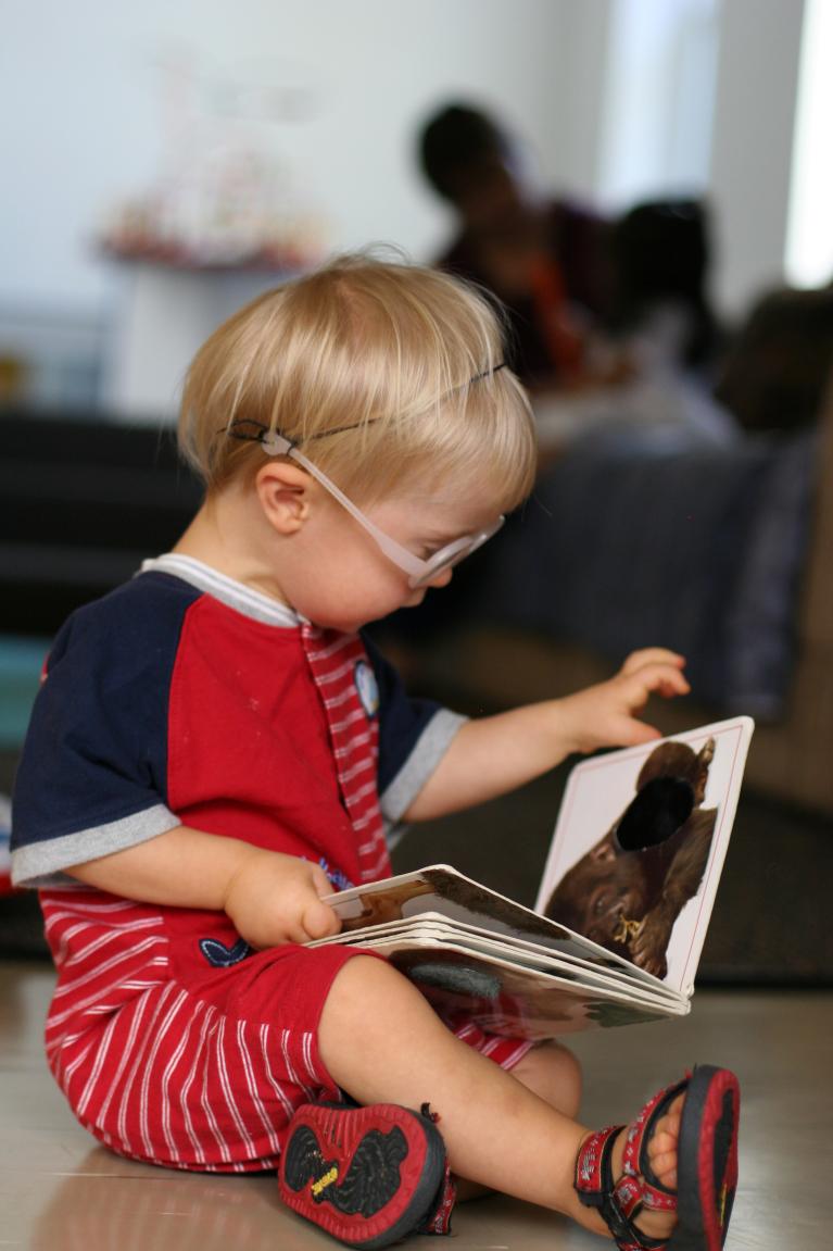 Infant reading a book